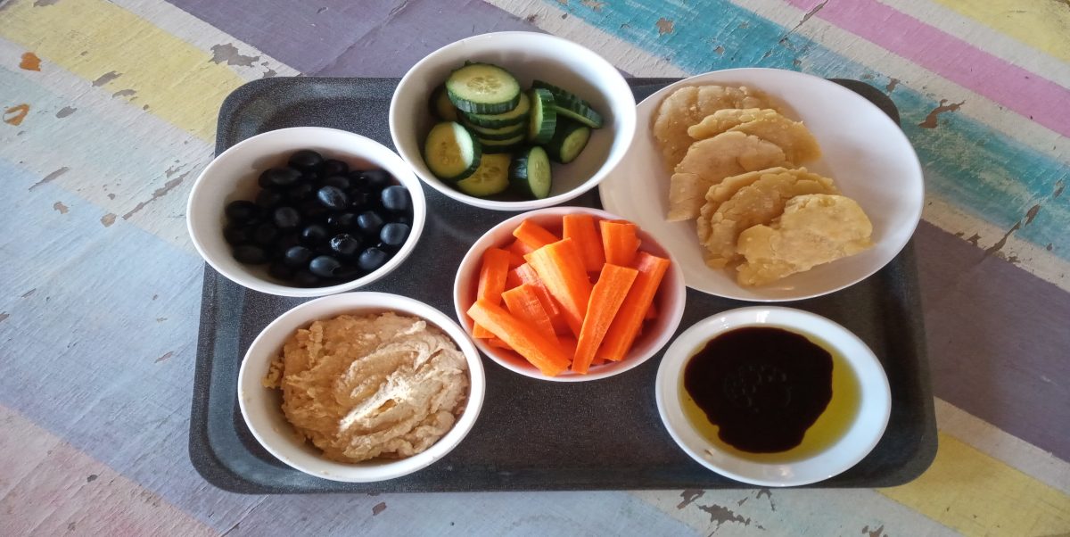 A simple starter of fresh vegetables, homemade gluten-free flat bread and houmous.